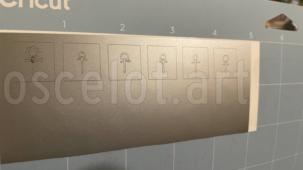 An image of one of my test cuts. Prominently shown is Beckett's ankh, the centre of which is just a ripped up pile of vinyl because there was too much detail.